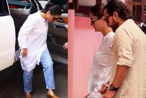 Kareena Kapoor Khan stumbles as she steps out of her car after she arrives with Saif to vote
