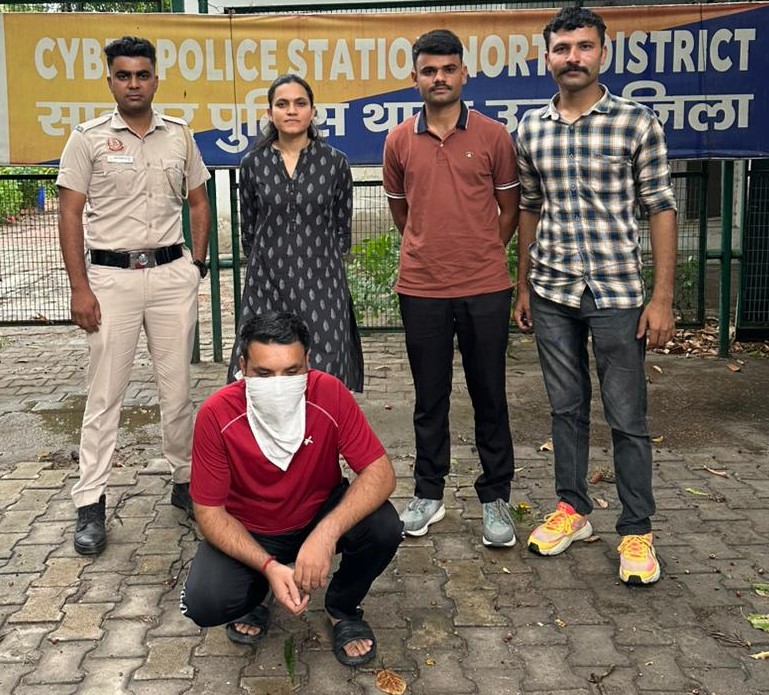 Police handcuffs on keyboard representing cyber extortion and arrest