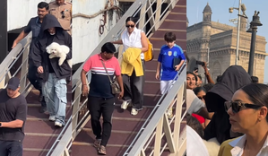 SRK tries to go incognito as he exits jetty with pet and family